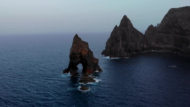 Drone orbit around arch cliff near Ponta de Sao Lourenco coast, Madeira island, Portugal