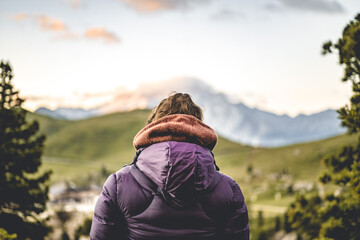 A woman is enjoying the sunrise in the Dolomites