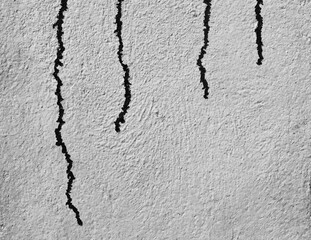 Abstract black and white background.Streaks of black paint on the light wall.Black oil paint on a white surface.
