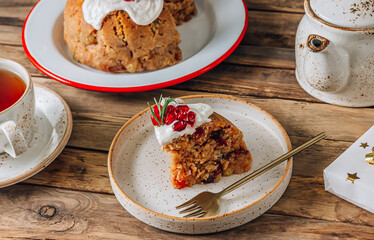 Traditional Christmas fruit pudding on festive background.