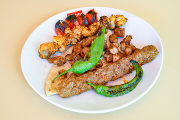 Beef steak grill with rice pilaf, fried potatoes, grilled pepper and tomatoes.Mix Platter with Beef rips, Cutlets, Potatoes and Sauces.