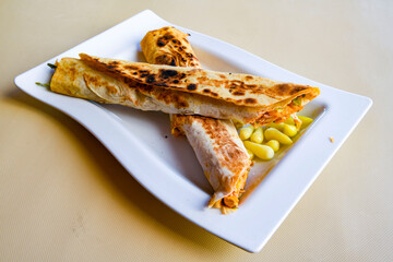 Lavash doner kebab ( zurna doner durum )  or shawarma sliced in plate isolated. 