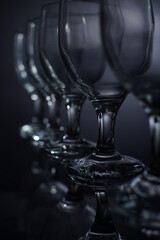 close up restaurant water glass leg with reflection in black background 