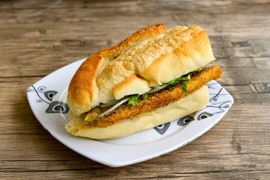 Close-up shot of Izmir's famous Turkish Traditional Kumru Sandwich, Ceşme Kumru, patso ingredients ready to eat salami, soudjouk, tomato, cheddar cheese and fried cheese. Yengen sandvic.