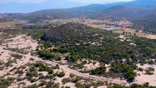 Patara (Lycian Captital) Ancient City and Beach aerial footage Antalya Turkey with ruins, lake, hills and sandy flora in summer sunny weather