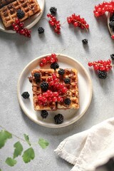 Waffles with berries on the table 