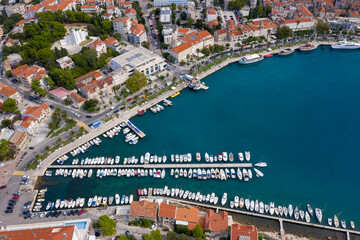 View of the harbor and city. Makarska riviera.Dolmatia.Blue south sea. Mountains, houses, yachts, ships, boats on the pier. City beach and pier. Drone footage. Summer. Adriatic. Relax. Vacation. 