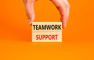 Teamwork support symbol. Concept words Teamwork support on wooden blocks on a beautiful orange table orange background. Businessman hand. Business and teamwork support concept. Copy space.