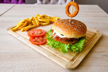 Big tasty  burger with beef cutlet on a plate. Hamburger.