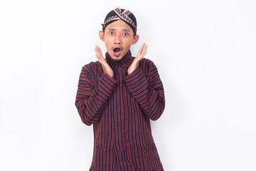 asian man with javanese traditional cloth lurik shocked isolated on white background