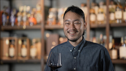Fototapeta premium Night club concept of 4k Resolution. Asian man tasting wine in a restaurant. A group of specialized clubs that sell alcoholic beverages.