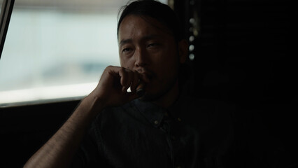 Night club concept of 4k Resolution. Asian man smoking cigar in restaurant. A group of specialized clubs that sell alcoholic beverages.