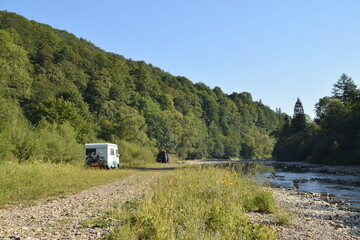 camper in the montains on the river