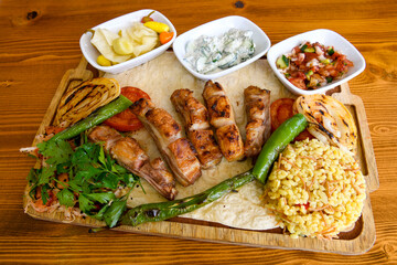 Beef steak grill with rice pilaf, fried potatoes, grilled pepper and tomatoes.Mix Platter with Beef rips, Cutlets, Potatoes and Sauces.
