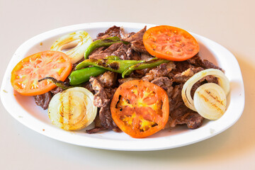 Beef steak grill with rice pilaf, fried potatoes, grilled pepper and tomatoes.Mix Platter with Beef rips, Cutlets, Potatoes and Sauces.