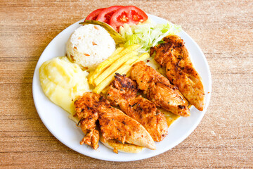Chicken wings barbeque in a dish with BBQ sauce . Izgara tavuk sis kanat.
