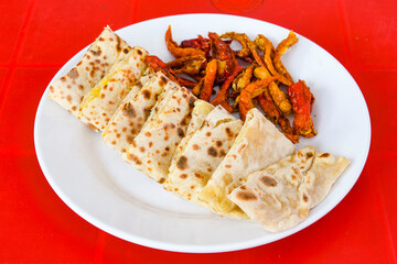 Turkish style meat stuffed filo dough borek served kol boregi. Cheese and minced pie are sliced on a marble background. Turkish name: Kol Boregi, kiymali, peynirli su boregi.