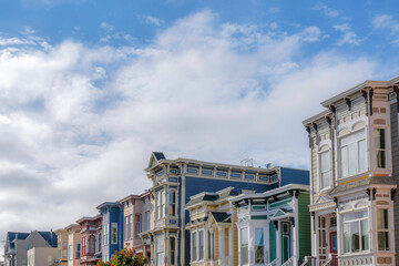 Fototapeta premium Townhomes with colorful wood vinyl sidings against the sky background