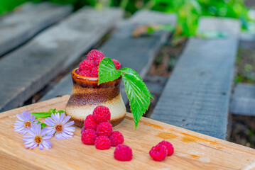 raspberries in a glass lie on a tray