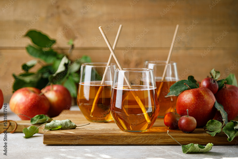 Sticker apple juice in a glass and fresh fruits with leaves