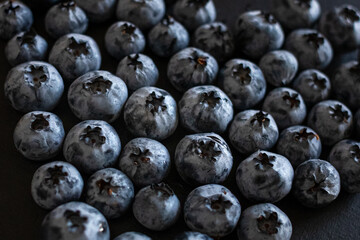 Handful of blueberries on black background. Handful of blueberries Ripe berries. Healthy Lifestyle. Useful products. Lots of vitamins.