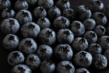 Handful of blueberries on black background. Handful of blueberries Ripe berries. Healthy Lifestyle. Useful products. Lots of vitamins.