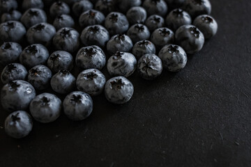 Handful of blueberries on black background. Handful of blueberries Ripe berries. Healthy Lifestyle. Useful products. Lots of vitamins.