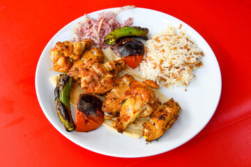 Chicken wings barbeque in a dish with BBQ sauce . Izgara tavuk sis kanat.