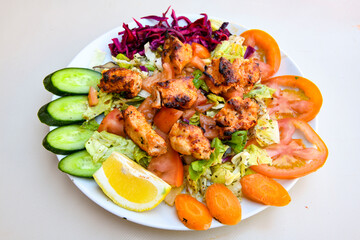 Turkish and Arabic Traditional Ramadan doner kebab with tasty tomato sauce and rice or turkish pilav in white plate on wood table background. ( Pilav ustu doner)