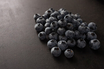 Handful of blueberries on black background. Handful of blueberries Ripe berries. Healthy Lifestyle. Useful products. Lots of vitamins.