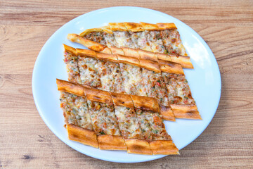 Turkish pita with minced cubed meat and cheese (Turkish name: Kiyma Kusbasi kasarli pide)