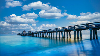 Fototapeta na wymiar Naples Pier on the beach, sunny day with beautiful clouds in Naples, Florida, USA