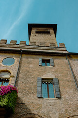 Detail of a beautiful old building in the historic center of Padua against the blue sky. Vertical image.