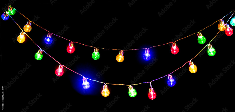 Wall mural colorful light bulbs garland isolated on black background. holiday backdrop, decor. beautiful christ