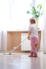 little daughter cleaning in the house, child dusting, Cute little helper girl washing floor with...
