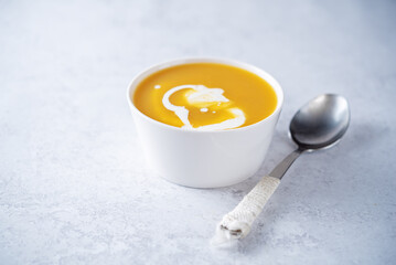Pumpkin soup with cream in a bowl