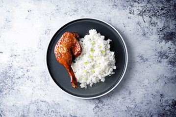Peking duck with rice on a plate
