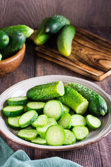Fresh sliced cucumbers on a plate on the table. Dietary organic food. Vertical view
