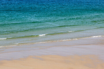 Fototapeta na wymiar The water's edge, at Sennen Beach in Cornwall