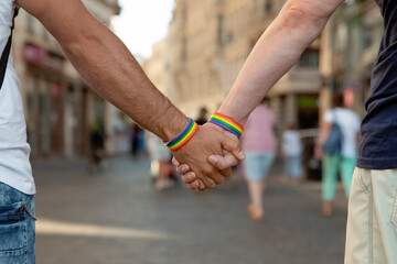 Obraz premium Two men walking around a European city with lgbt symbols, concept