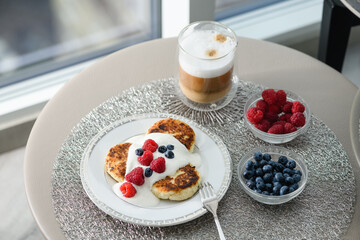 Top view of cottage cheese pancakes with blueberries and raspberries.