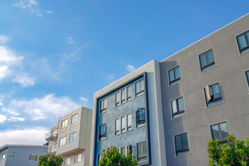 Modern apartment buildings with gray, blue, and white exterior in San Francisco, California