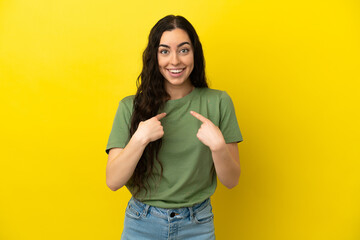 Young caucasian woman isolated on yellow background with surprise facial expression