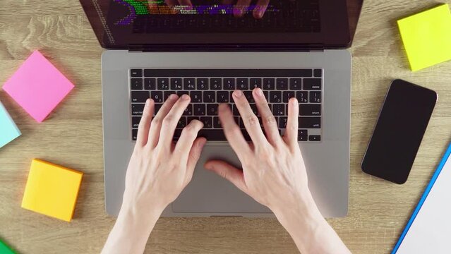 Hands are typing program code on the HTML programming language