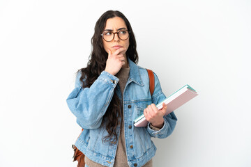 Young student woman isolated on white background having doubts