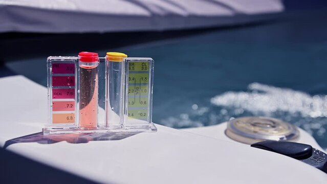 Hot Tub Water Quality Check by Using Chemical Testing Kit. pH, Chlorine and Bromine Concentration. Garden SPA Water Maintenance.