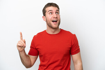 Young caucasian man isolated on white background pointing up and surprised