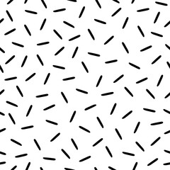 Memphis style chaseamless pattern. Chaotic short lines irregular vector texture on white background.