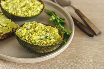 home cooked avocado and egg pate in shells and toast with it on a plate