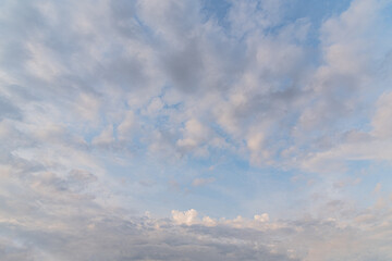 Naklejka na ściany i meble abstract background of white fluffy clouds on a bright blue sky